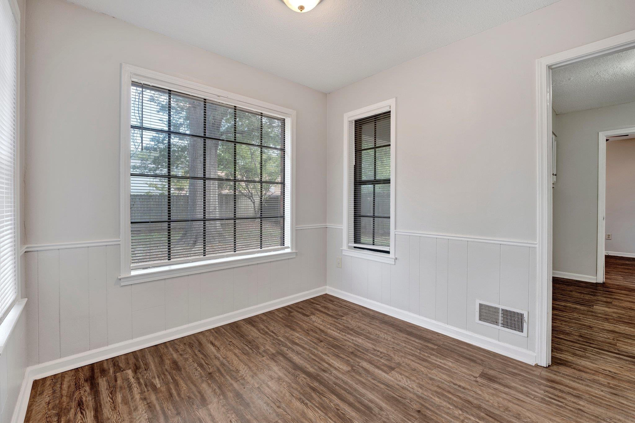 4988 Ridge Tree Drive Memphis, TN 38128 - Photo 8 of 22 a view of an empty room with wooden floor and a window
