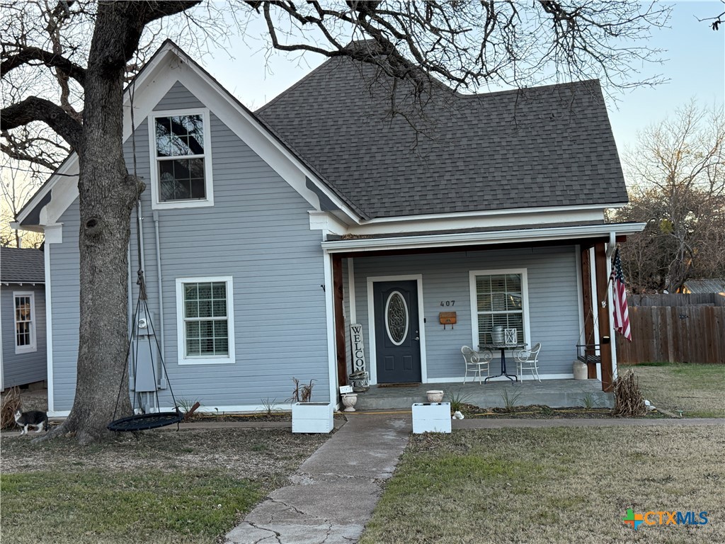 a house that has a tree in front of the house