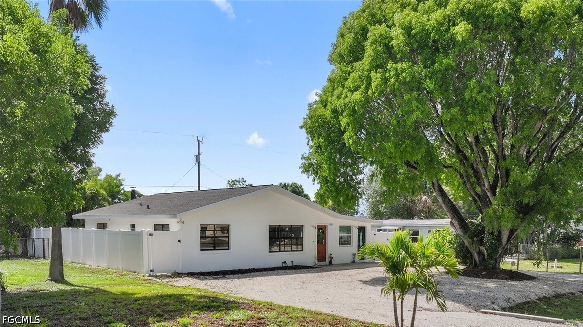 1200 Patterson Road Cape Coral, FL 33909 - Photo 34 of 42 a house with a tree in front of it