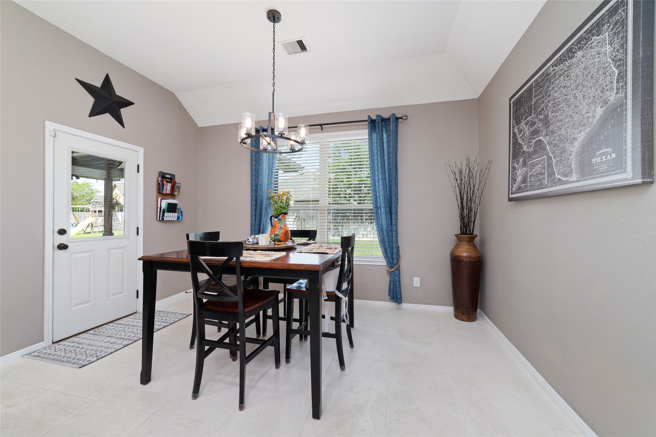 9902 Indian Rill Court Tomball, TX 77375 - Photo 11 of 34 The spacious dining room is located right next to the kitchen. The door leads into the backyard by stepping into the custom extended patio with cool deck & vaulted T&G ceiling!