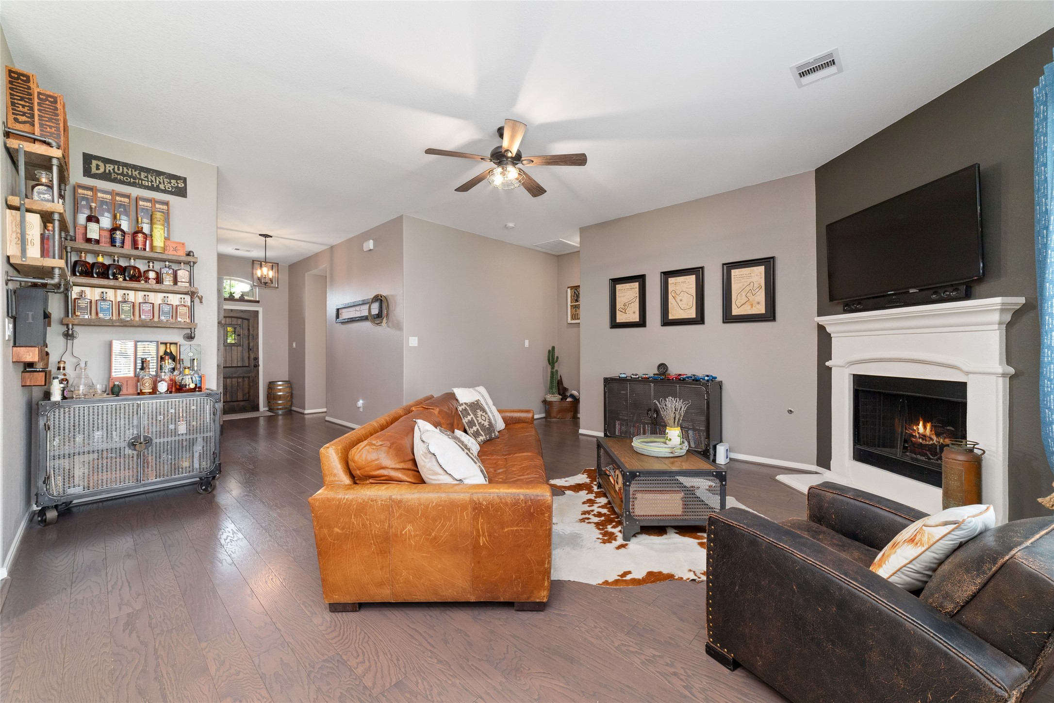 9902 Indian Rill Court Tomball, TX 77375 - Photo 12 of 34 The primary suite is conveniently located off the living room to the right, connected by a private hallway.