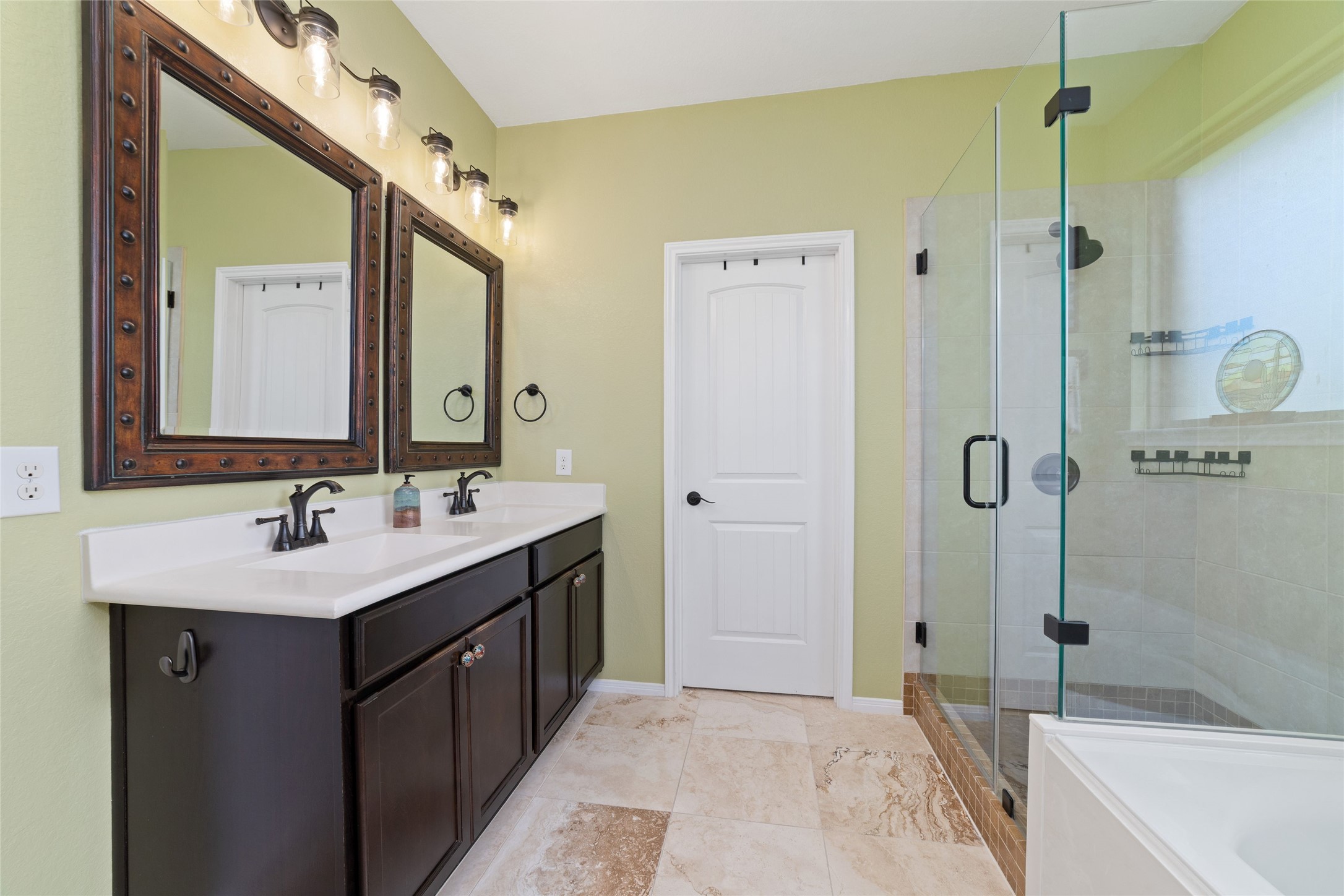 9902 Indian Rill Court Tomball, TX 77375 - Photo 15 of 34 Upgraded primary bathroom with double sink vanity with white cultured marble countertop, new floor tile, frameless glass shower enclosure, and soaking tub. Separate water closet. Straight ahead is the huge 12x9 walk-in closet.