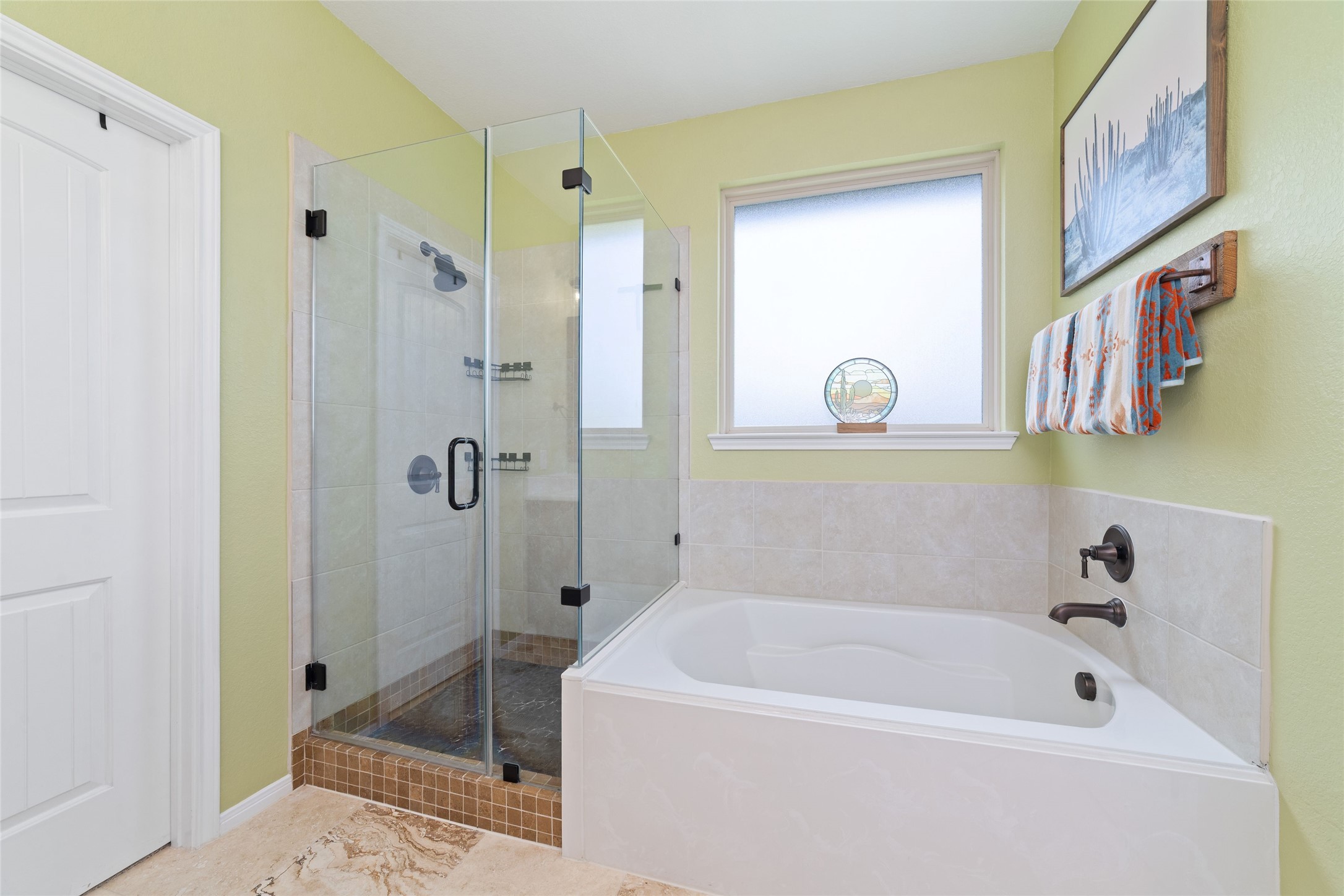 9902 Indian Rill Court Tomball, TX 77375 - Photo 16 of 34 Upgraded primary bathroom with double sink vanity with white cultured marble countertop, new floor tile, frameless glass shower enclosure, and soaking tub. Separate water closet. Straight ahead is the huge 12x9 walk-in closet.