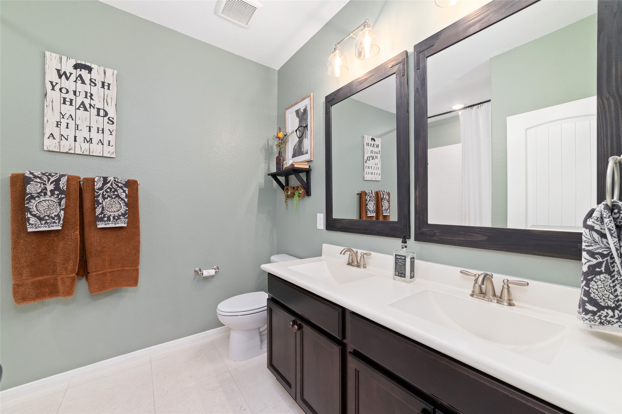 9902 Indian Rill Court Tomball, TX 77375 - Photo 20 of 34 Secondary bathroom with matching white cultured marble countertop, double sinks, and tub/shower combo. Adjacent is a linen closet for extra storage.