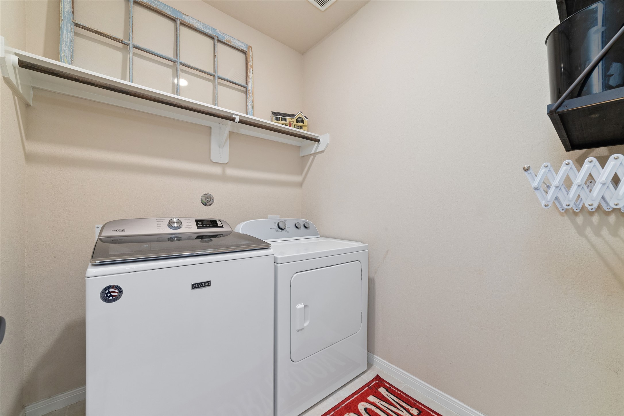 9902 Indian Rill Court Tomball, TX 77375 - Photo 22 of 34 Large laundry room with overhead hanging rack and storage shelf.
