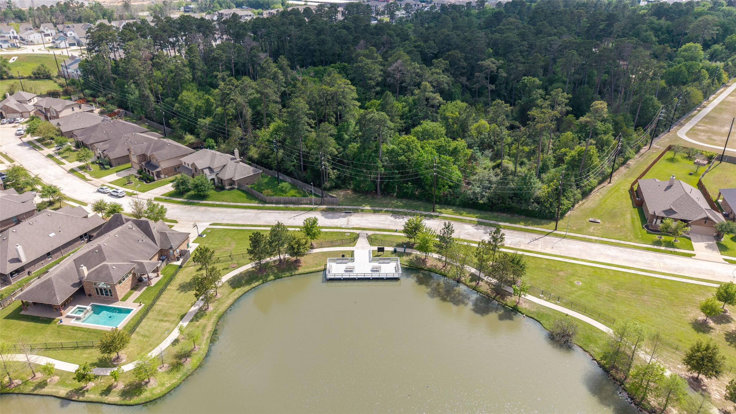 9902 Indian Rill Court Tomball, TX 77375 - Photo 29 of 34 The neighborhood lake offers a fishing pier, picnic tables, and trails.