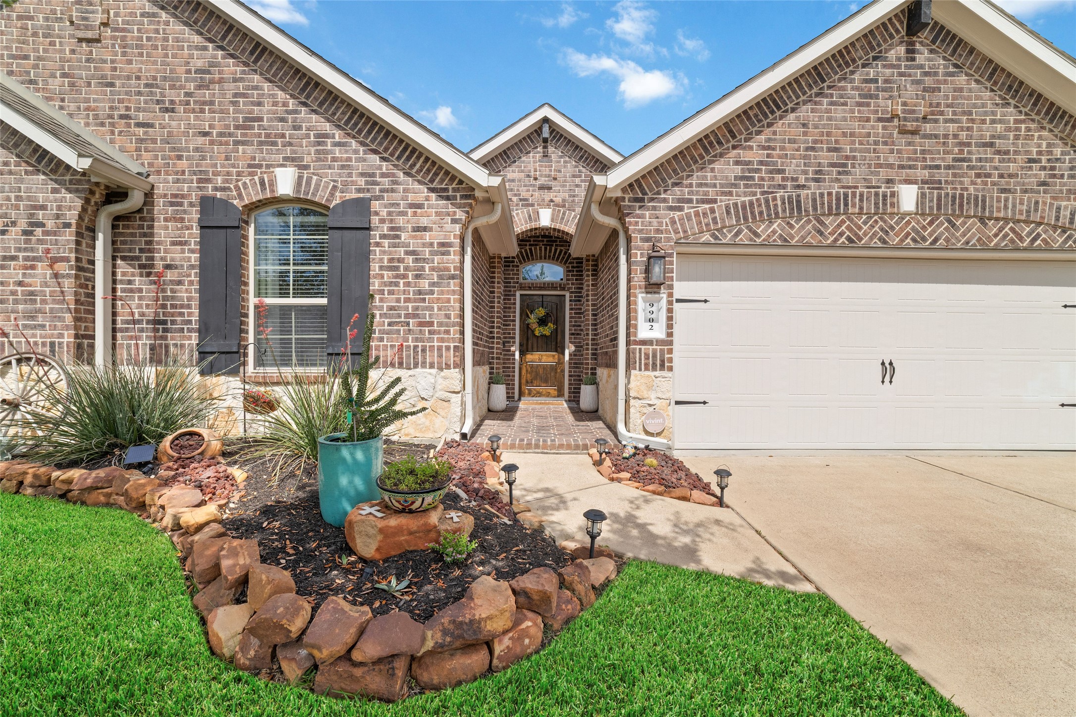 9902 Indian Rill Court Tomball, TX 77375 - Photo 3 of 34 As you drive up you'll immediately notice the custom western inspired landscaping with rock border and trees. All brick 1-story home!