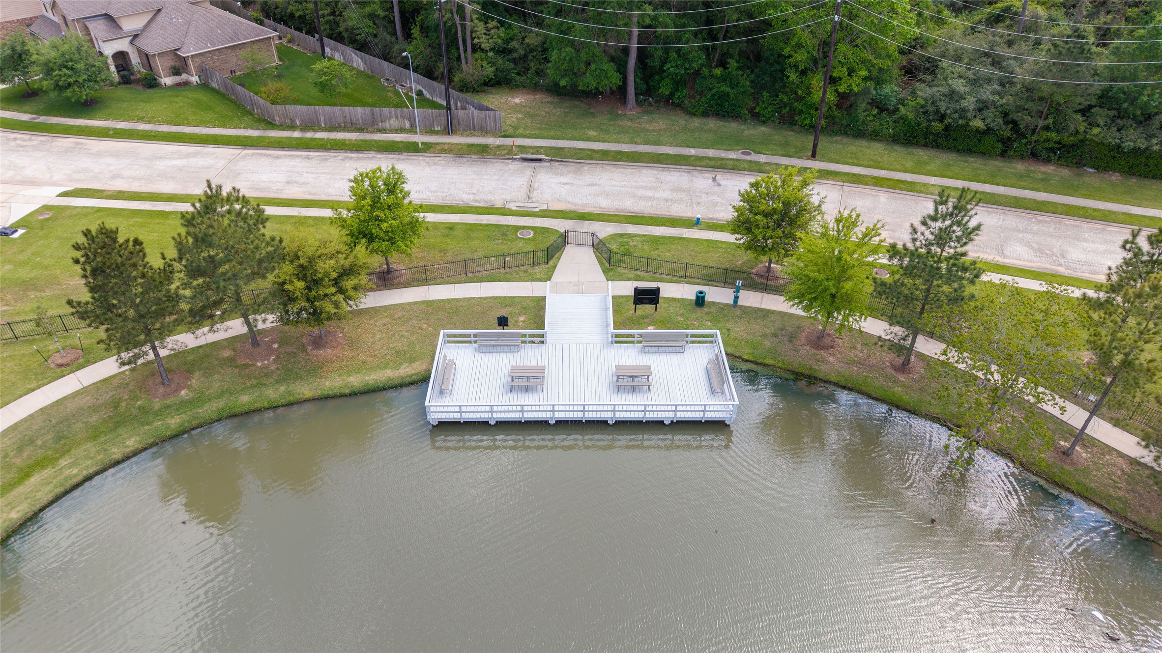 9902 Indian Rill Court Tomball, TX 77375 - Photo 30 of 34 The neighborhood lake offers a fishing pier, picnic tables, and trails.