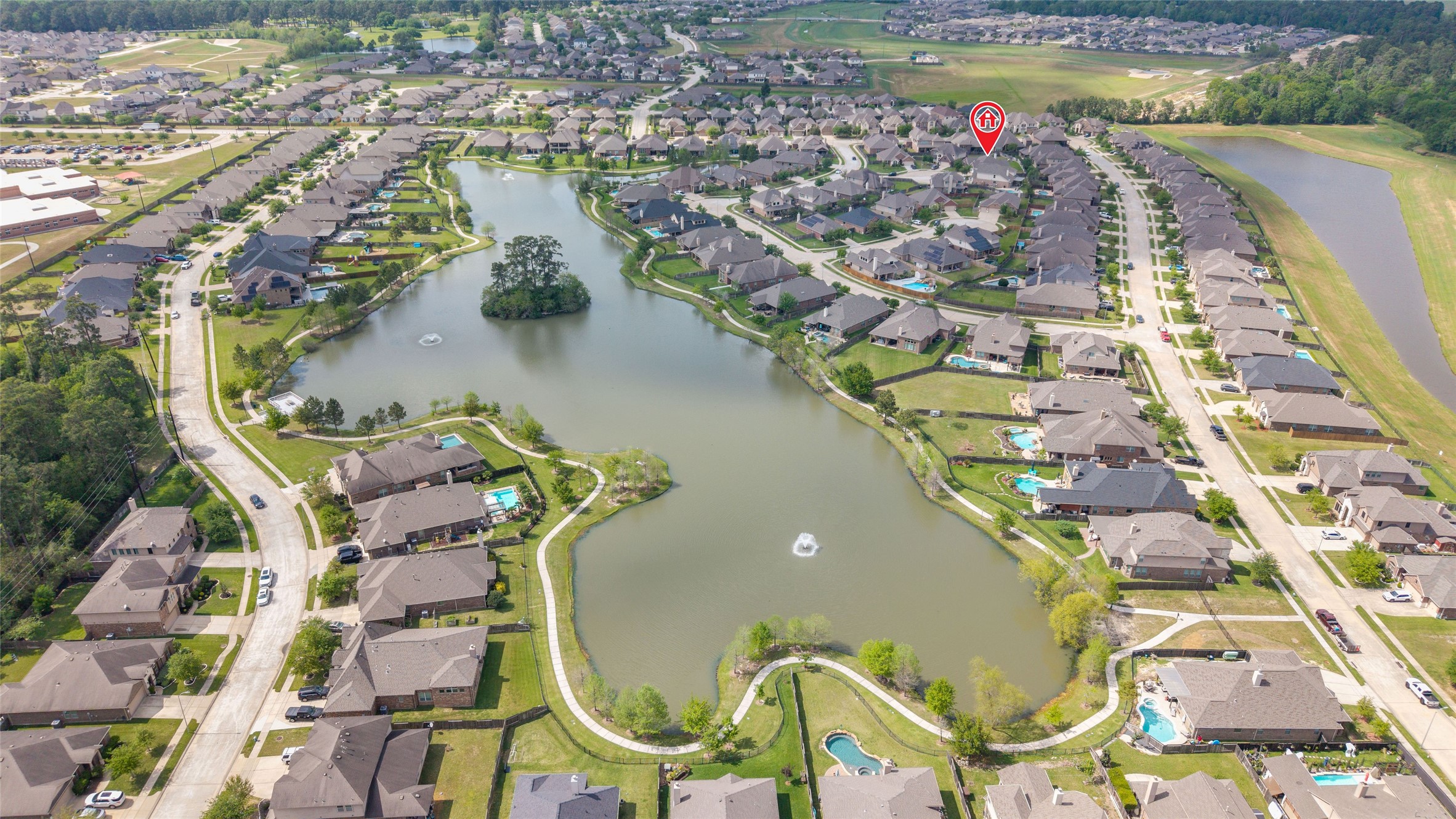 9902 Indian Rill Court Tomball, TX 77375 - Photo 32 of 34 The neighborhood lake offers a fishing pier, picnic tables, and trails.