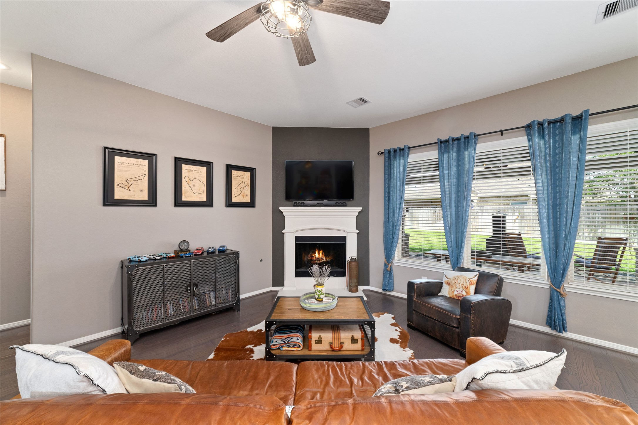 9902 Indian Rill Court Tomball, TX 77375 - Photo 5 of 34 Gas-log fireplace with cast stone surround & mantel ties the living room together. Unobstructed views looking out to the custom covered patio and private, fully fenced backyard.