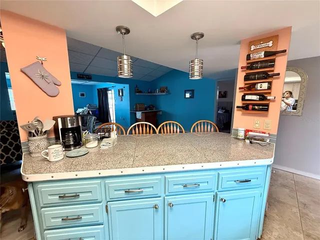 a dining room with furniture a rug and a chandelier