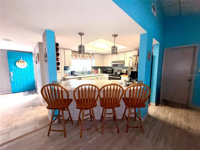 a dining room with furniture and wooden floor