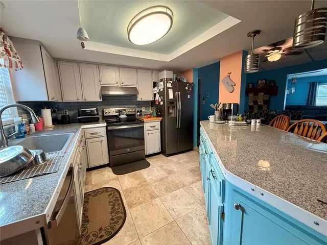 a bathroom with a granite countertop sink a mirror and vanity