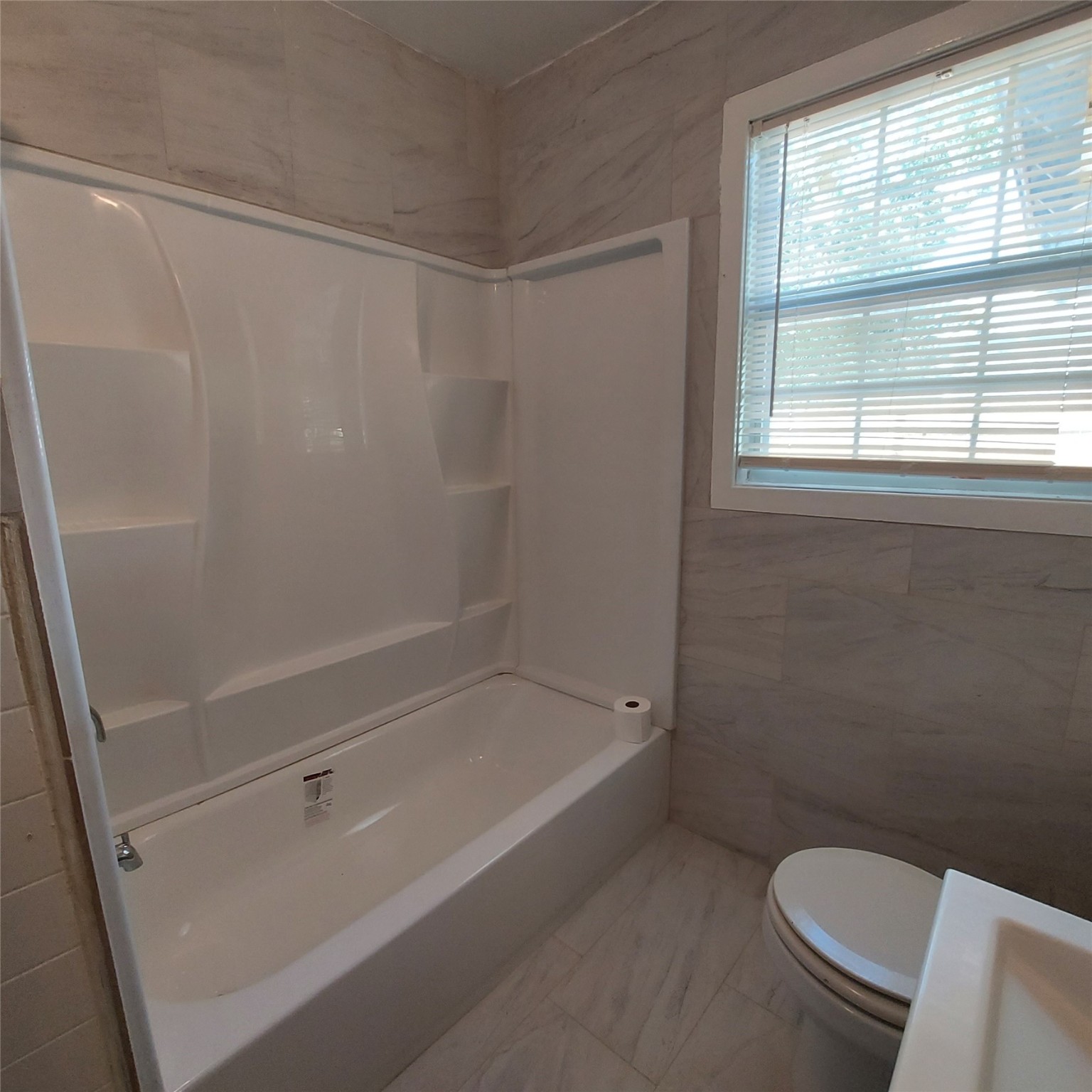 1025 6th Street, Unit A Hempstead, TX 77445 - Photo 3 of 11 New tub and enclosure and tile in bathroom