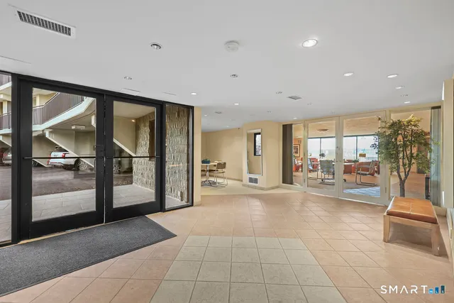 a lobby with furniture and floor to ceiling window
