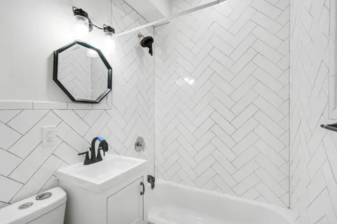 a bathroom with a sink a mirror and a shower curtain