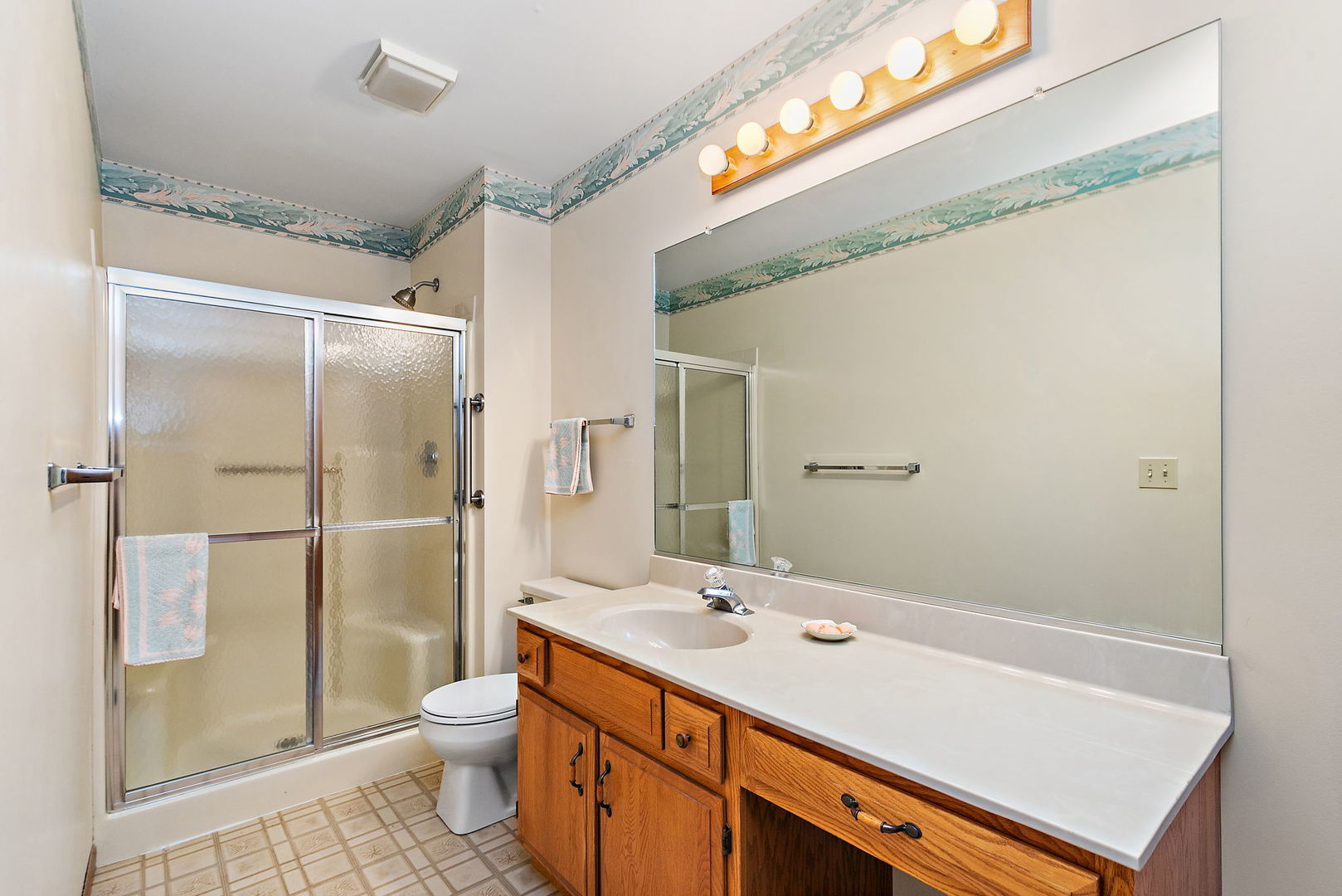 682 Alice Place, Unit 682 Elgin, IL 60123 - Photo 14 of 18 a bathroom with a shower sink and mirror