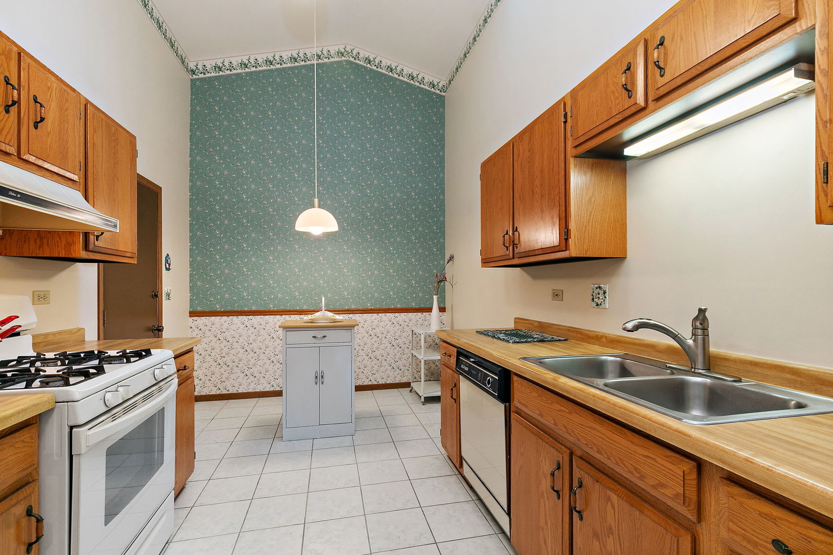 682 Alice Place, Unit 682 Elgin, IL 60123 - Photo 7 of 18 a kitchen with stainless steel appliances granite countertop a sink and cabinets