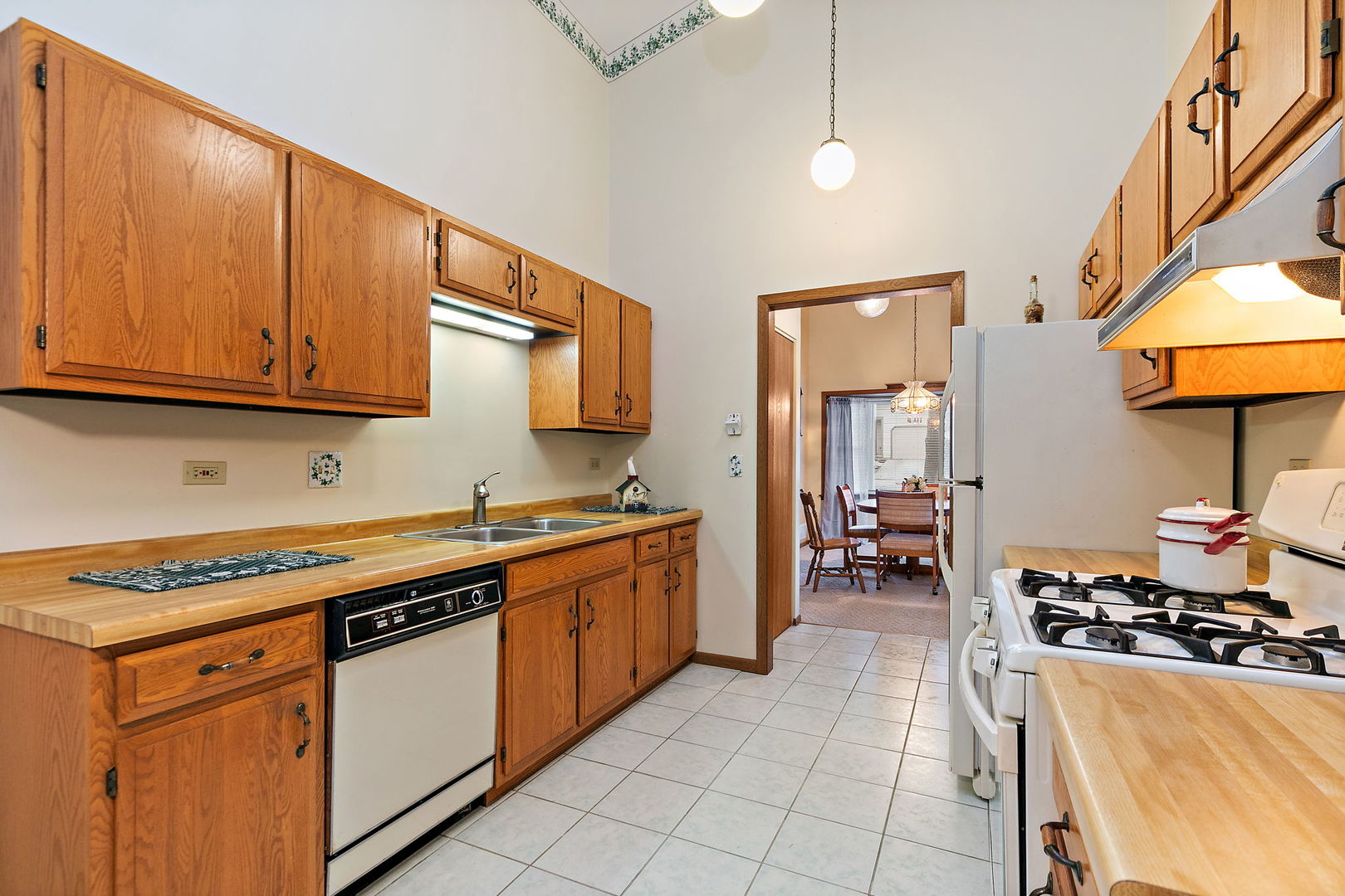 682 Alice Place, Unit 682 Elgin, IL 60123 - Photo 8 of 18 a kitchen with stainless steel appliances a stove a sink and a microwave