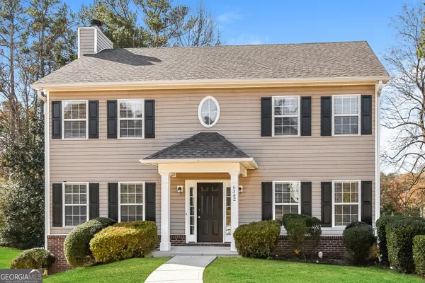 a front view of a house with garden