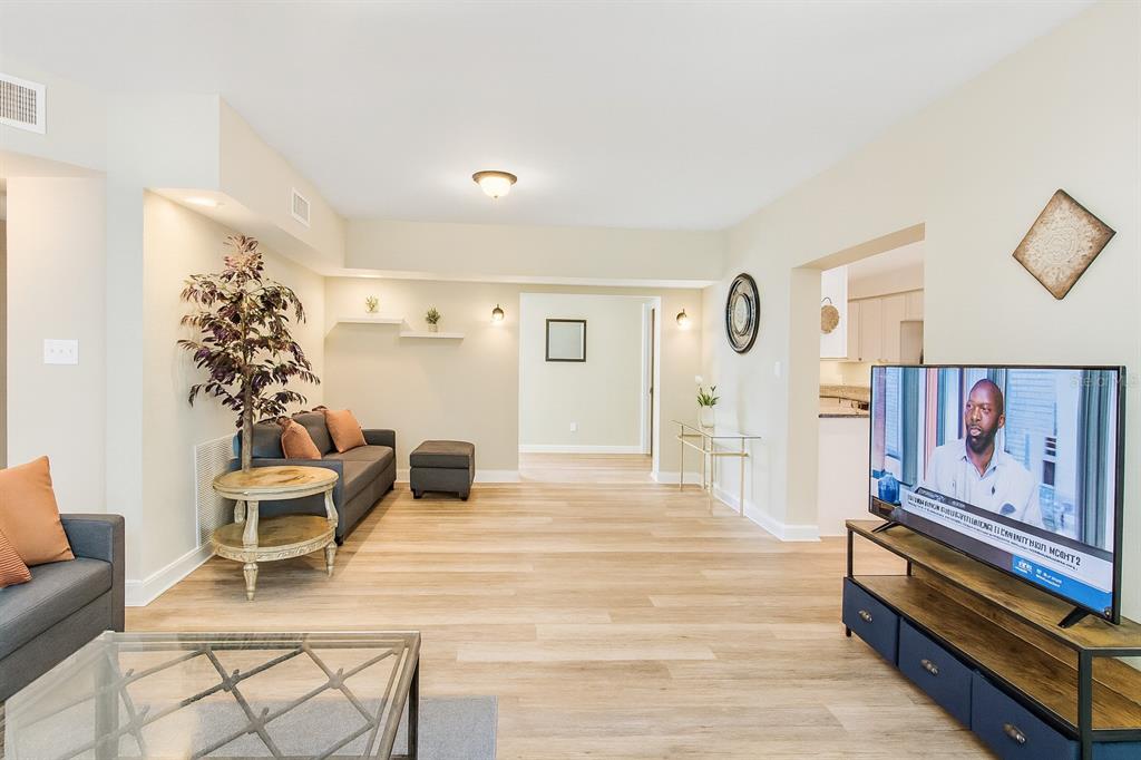a living room with furniture and a potted plant