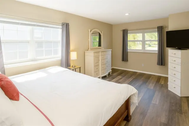 a bed sitting in a bedroom next to a window