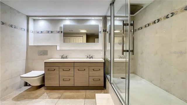 a bathroom with a shower sink and mirror