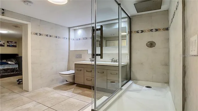 a bathroom with a granite countertop sink toilet and shower
