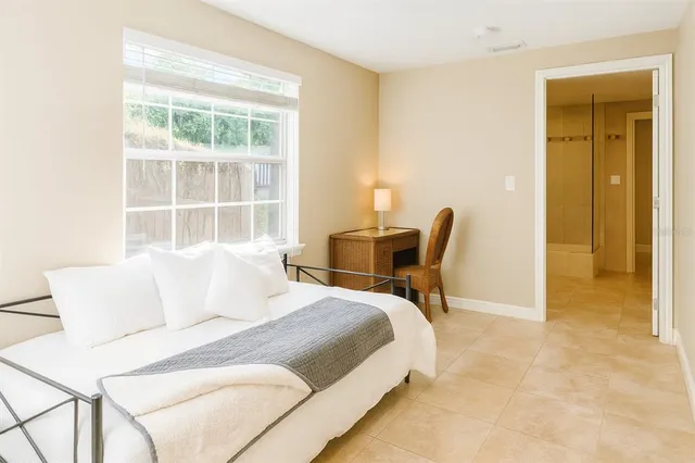 a bedroom with bed and a window