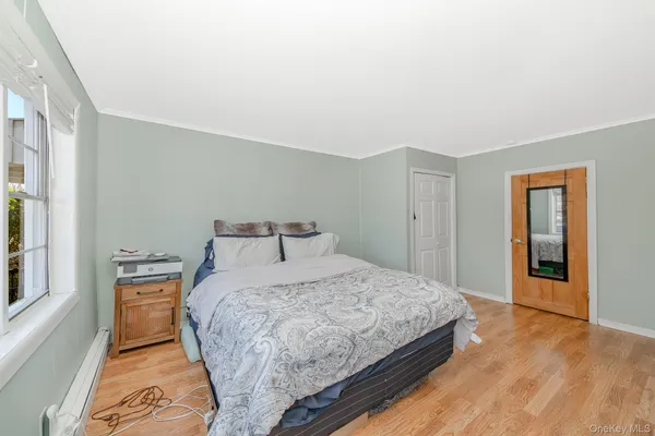 a bedroom with a bed and a large mirror