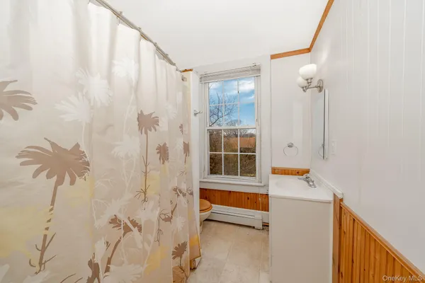 a view of a bathroom with a tub and shower