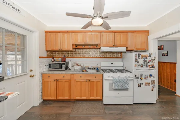 a kitchen with a stove a sink and a refrigerator