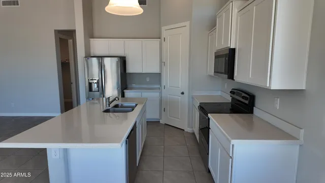 a kitchen with a sink a stove and refrigerator