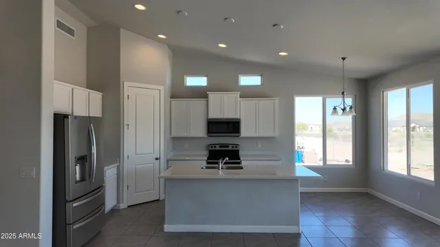 a kitchen with refrigerator and window
