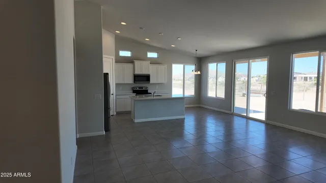 a view of a kitchen with a sink and a large window