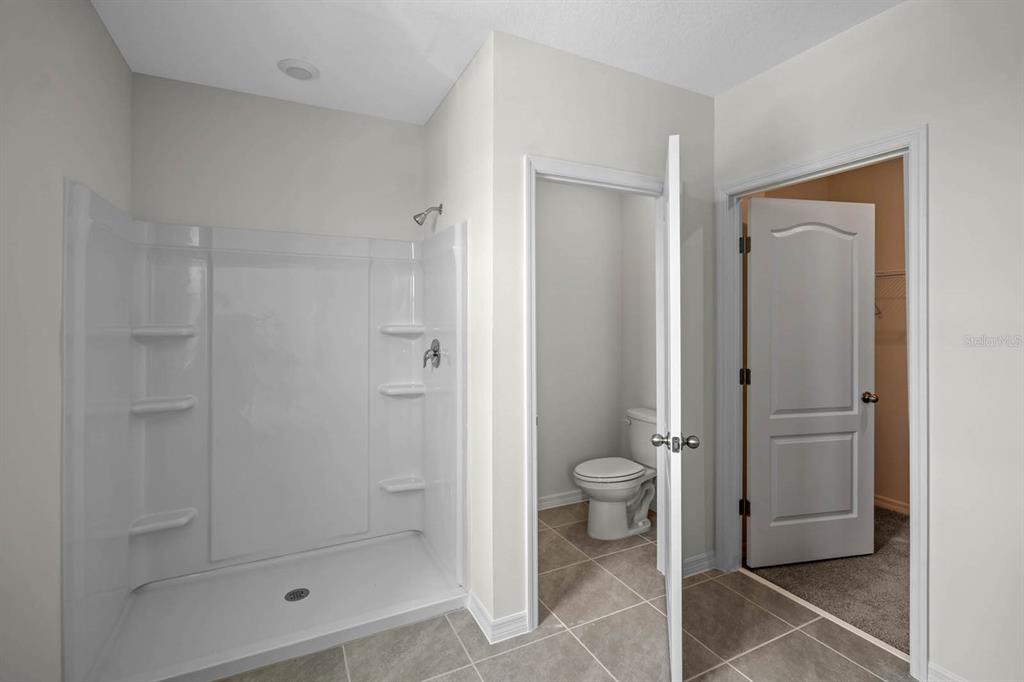 1217 Alstonia Mount Mount Dora, FL 32757 - Photo 23 of 33 a bathroom with a shower and toilet