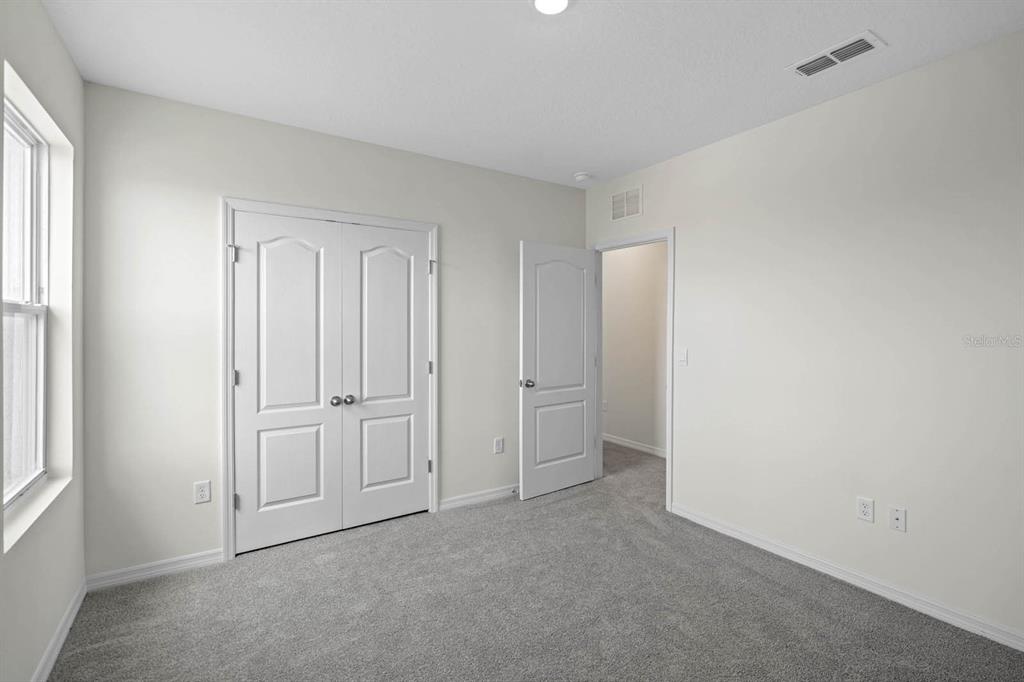 1217 Alstonia Mount Mount Dora, FL 32757 - Photo 27 of 33 an empty room with windows and closet