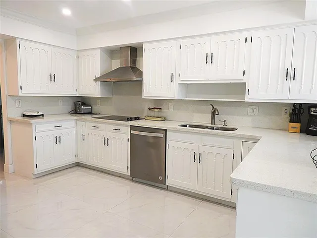 a kitchen with cabinets stainless steel appliances and a window