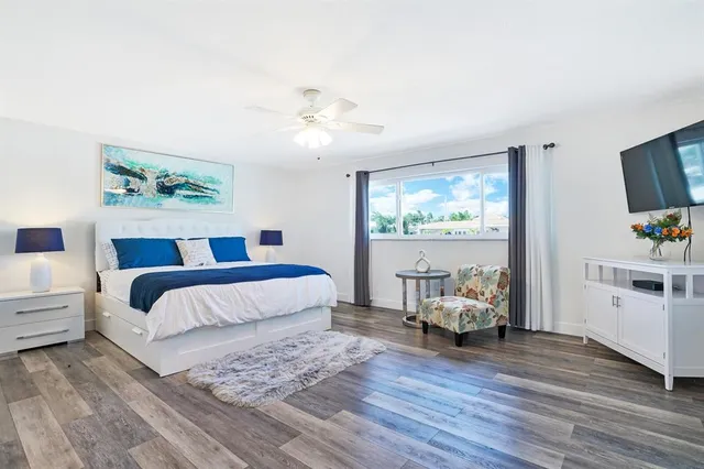 a bedroom with a large bed and a window