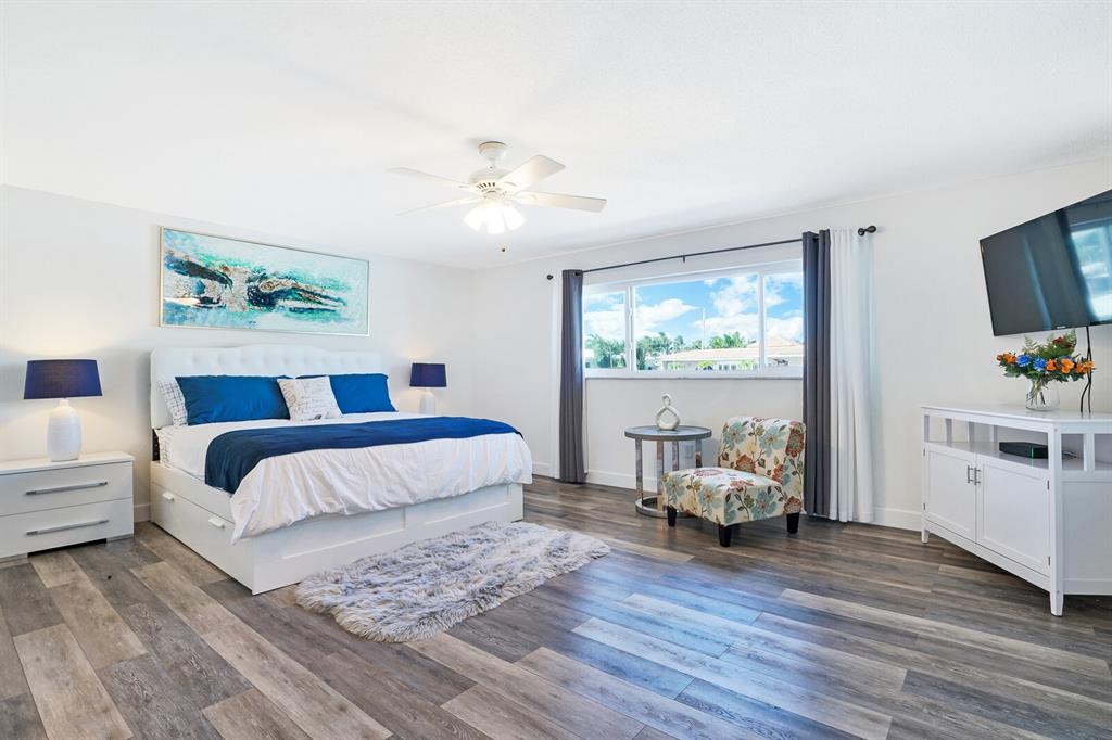 4101 Northeast 24th Avenue Lighthouse Point, FL 33064 - Photo 15 of 30 a spacious bedroom with a bed and a couch