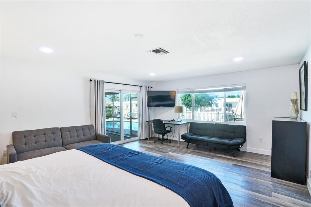 4101 Northeast 24th Avenue Lighthouse Point, FL 33064 - Photo 21 of 30 a bedroom with a bed and wooden floor