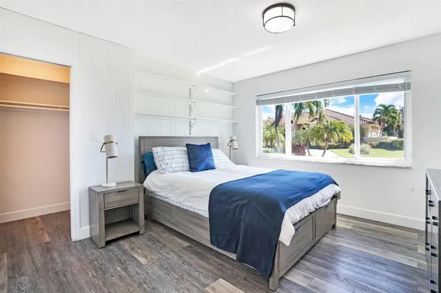 a bedroom with two beds and a large window
