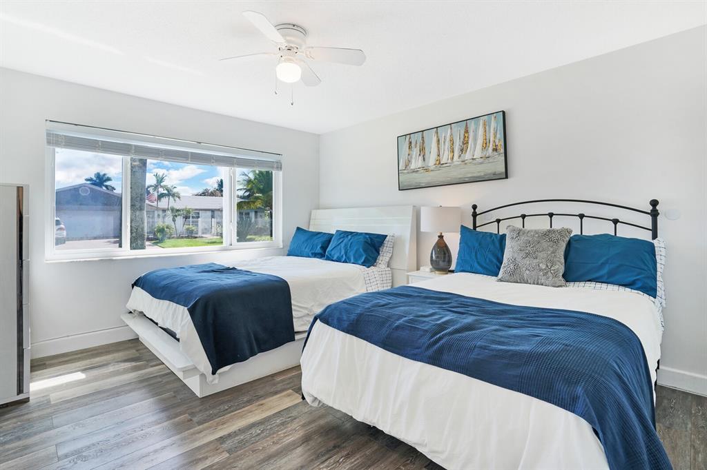 4101 Northeast 24th Avenue Lighthouse Point, FL 33064 - Photo 24 of 30 a bedroom with two beds and a large window