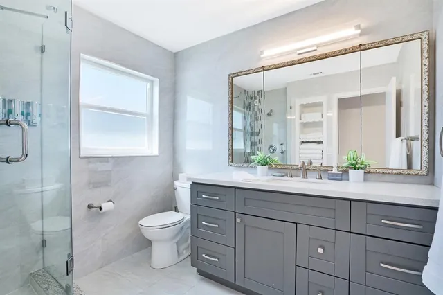a dining room with furniture water view and a floor to ceiling window