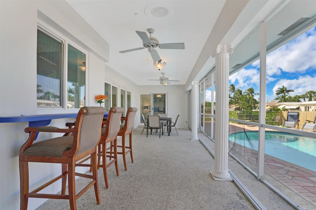 4101 Northeast 24th Avenue Lighthouse Point, FL 33064 - Photo 26 of 30 a dining room with furniture water view and a floor to ceiling window