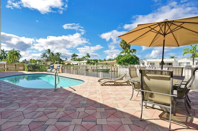 a swimming pool with outdoor seating and yard