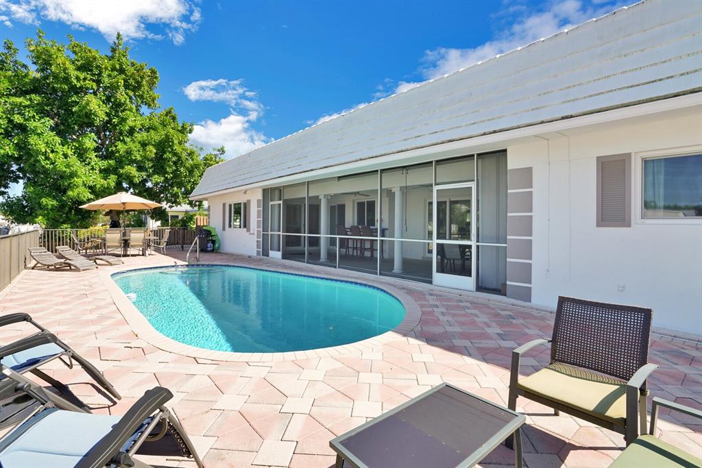 4101 Northeast 24th Avenue Lighthouse Point, FL 33064 - Photo 28 of 30 a swimming pool with outdoor seating and yard