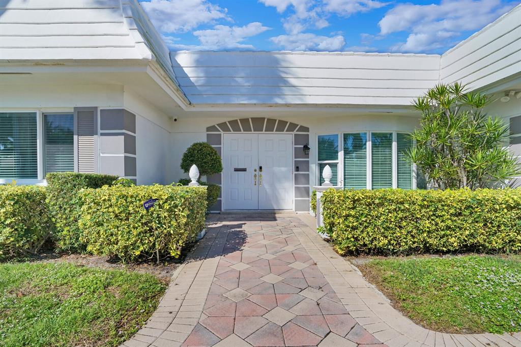 4101 Northeast 24th Avenue Lighthouse Point, FL 33064 - Photo 3 of 30 a front view of a house with garden