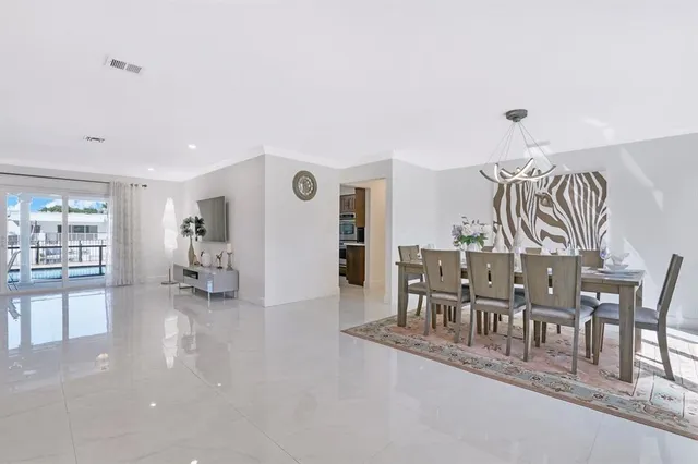 a view of a livingroom with furniture and floor to ceiling window