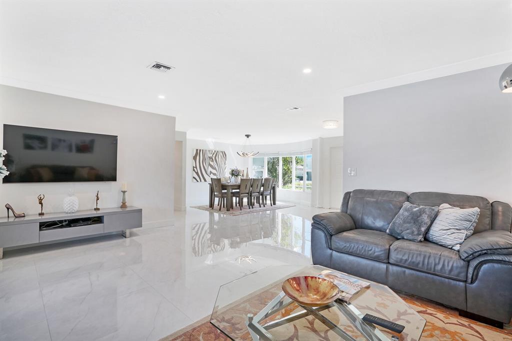 4101 Northeast 24th Avenue Lighthouse Point, FL 33064 - Photo 10 of 30 a living room with furniture and a flat screen tv